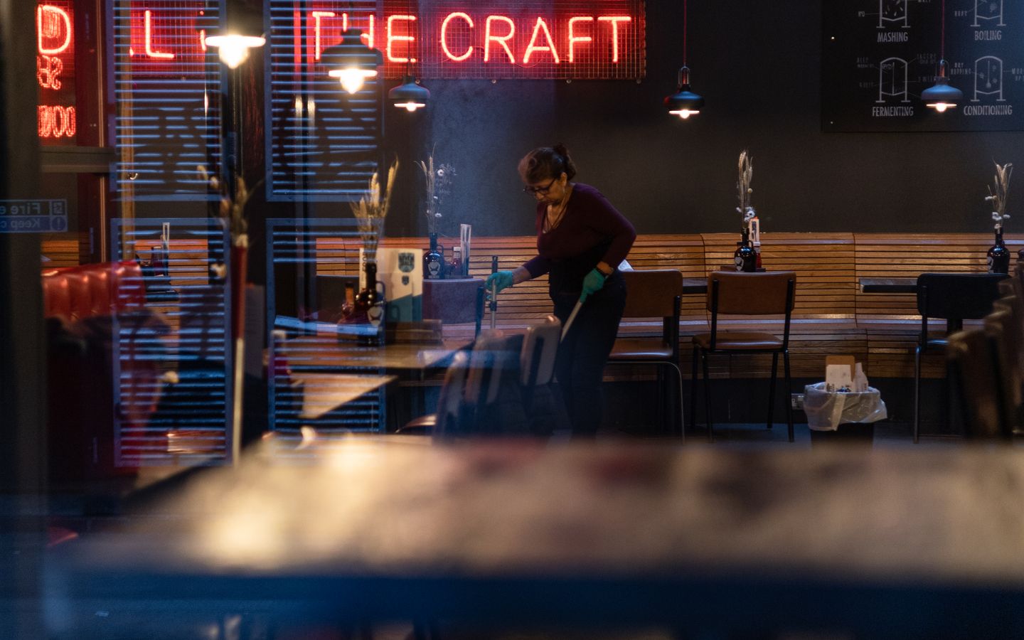Professional cleaner maintaining an upscale commercial dining space